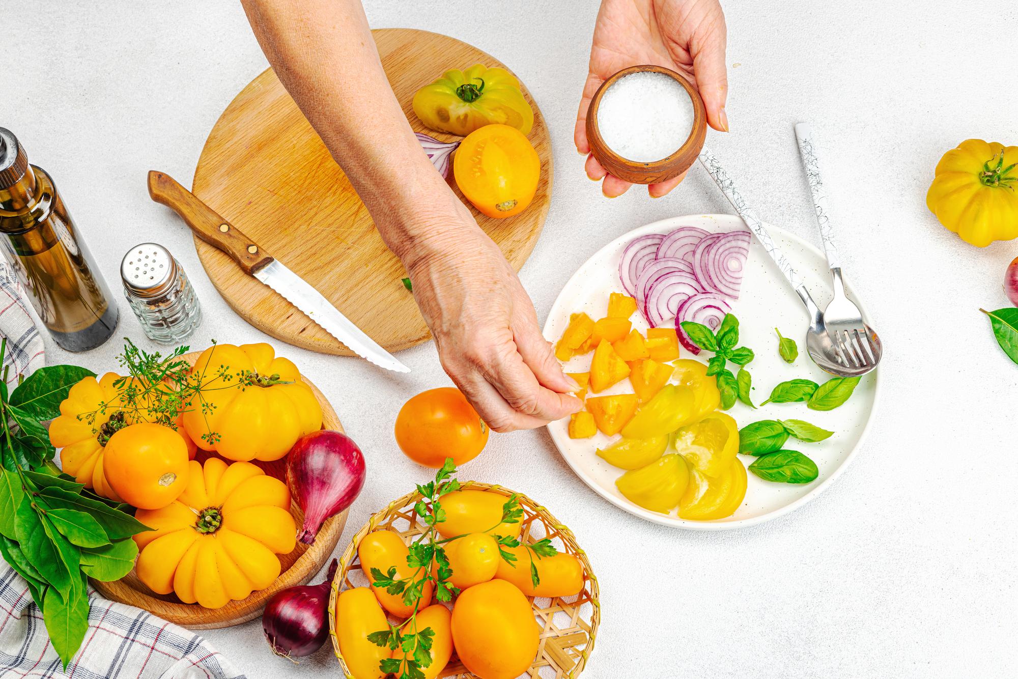 chef arranging a seasonal plate on wooden table
